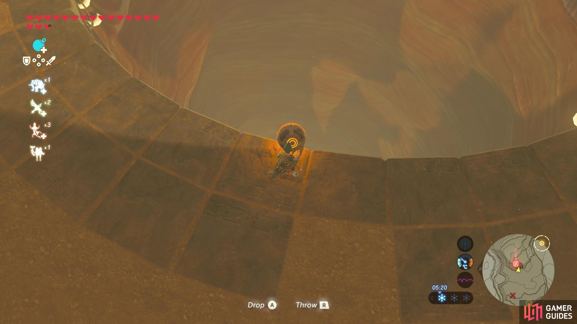 Drop the orb into the giant pit to spawn in the shrine!