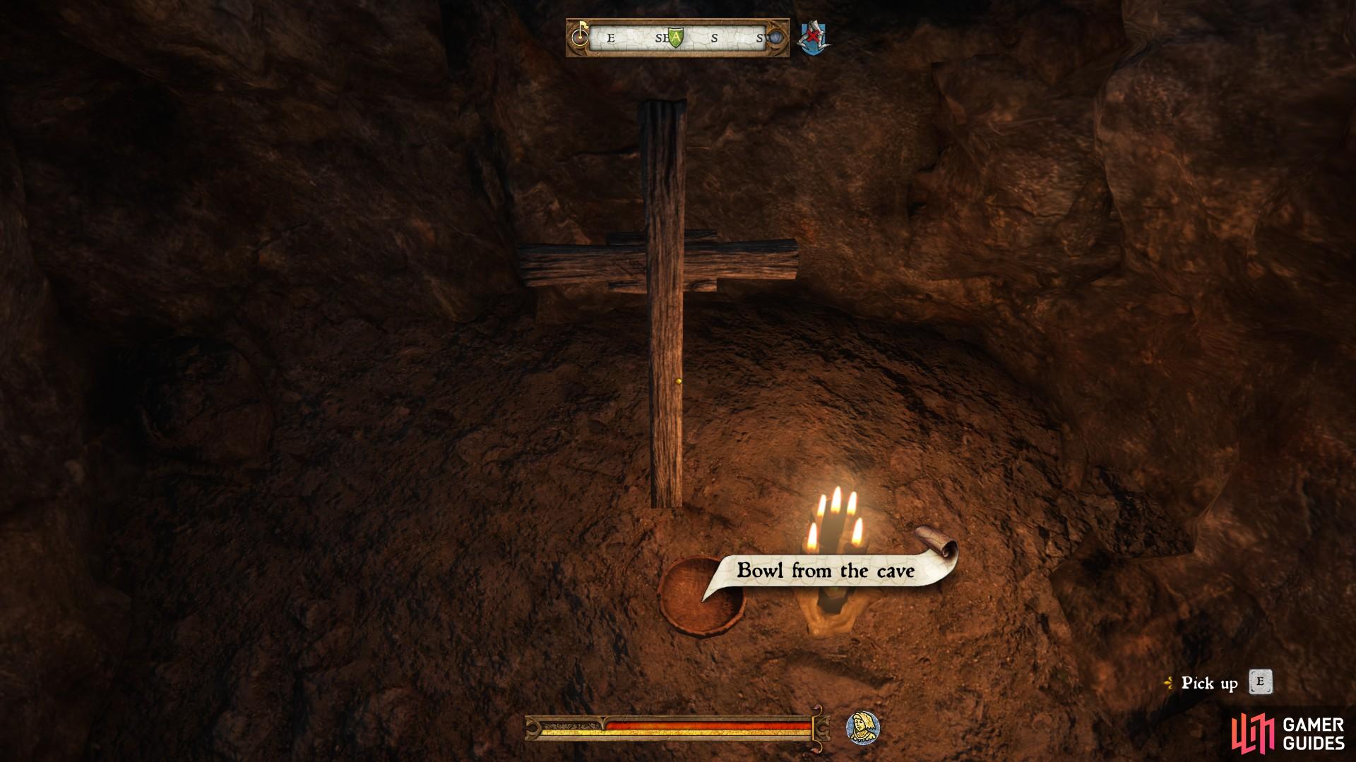 Once inside, you will find a small bowl beneath a cross. Pick it up to trigger the next phase of the quest.