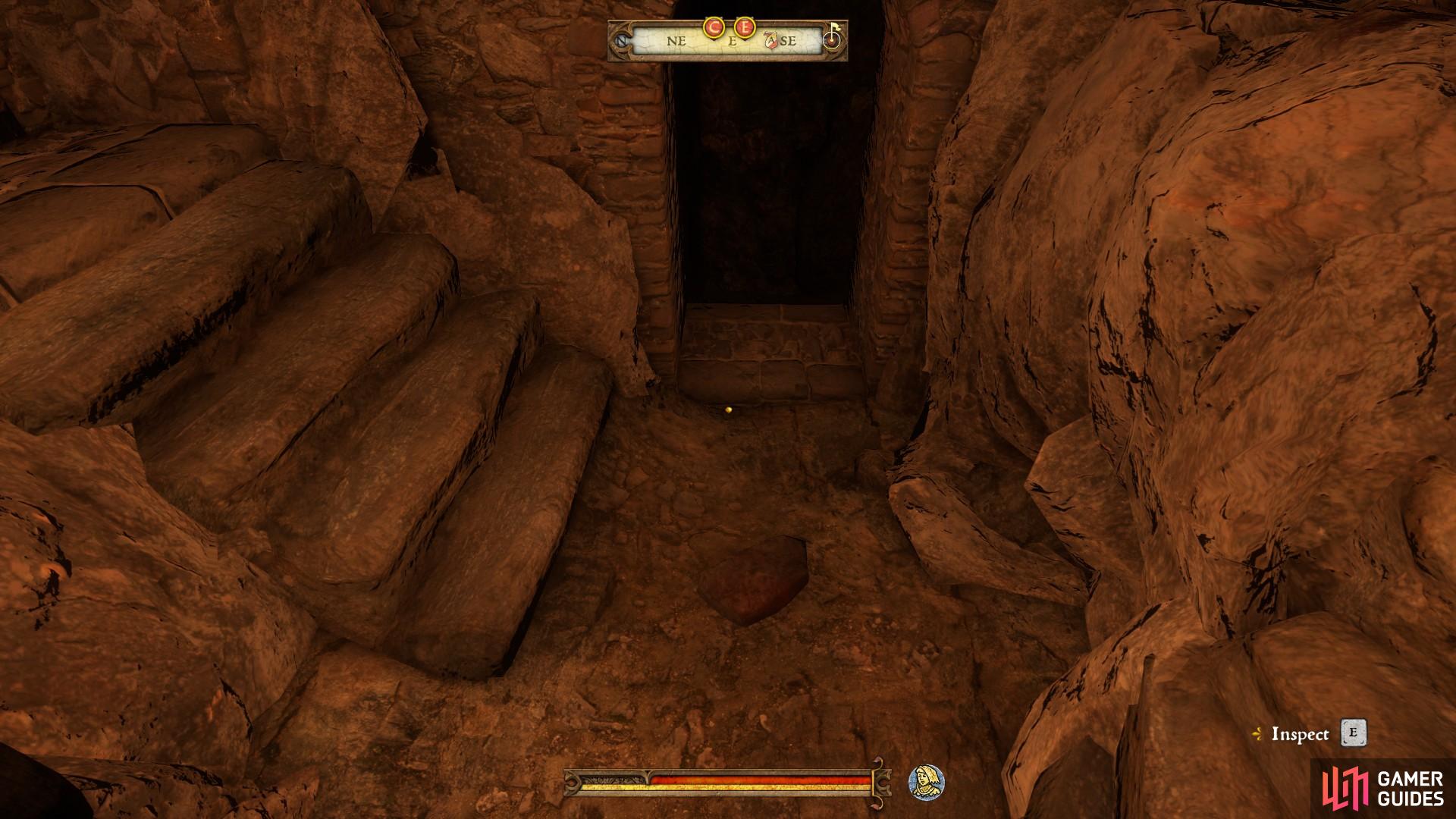 You can find the stone on the floor at the entrance to the catacombs.